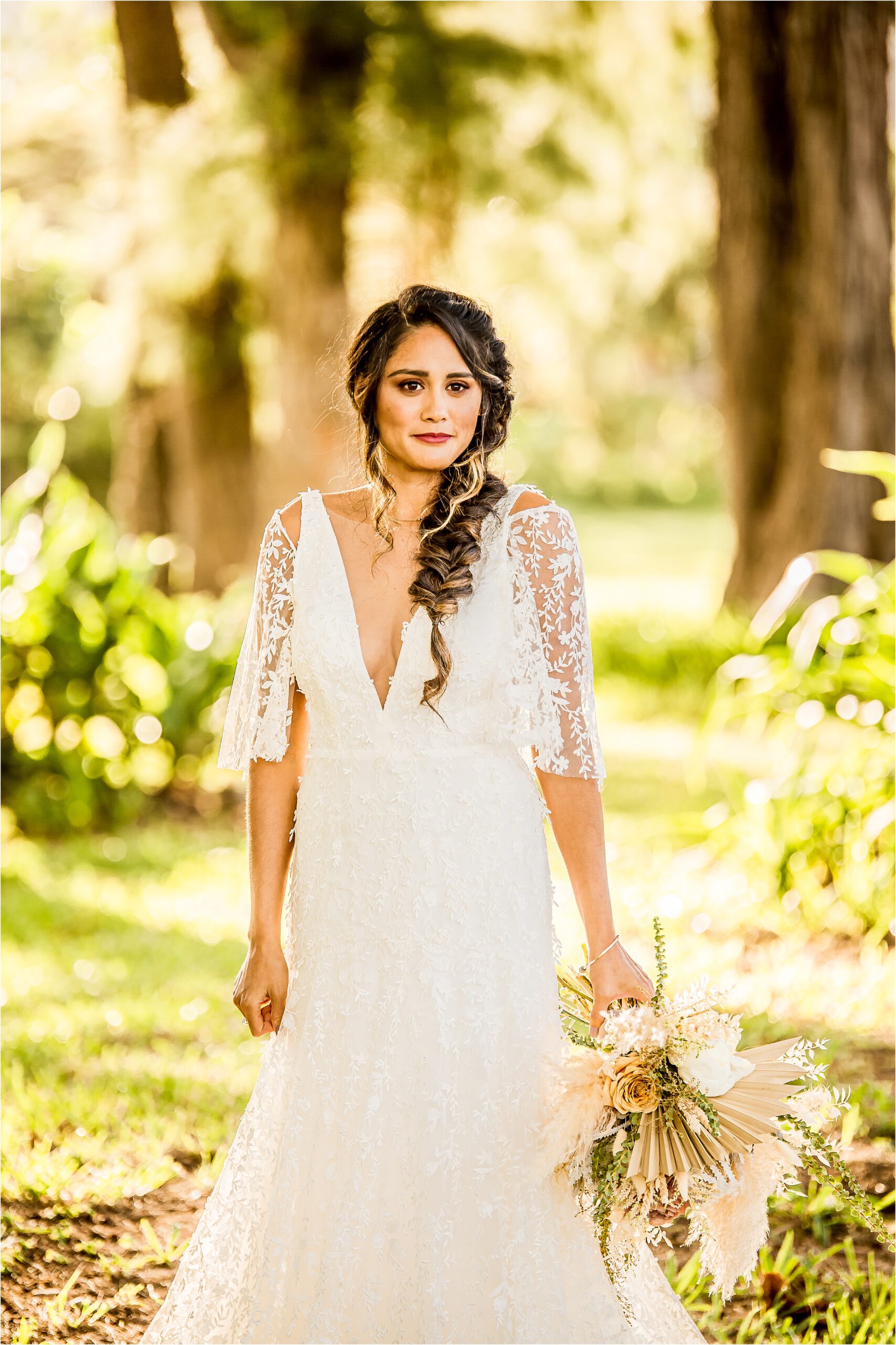 Wedding photography of Bride with a brown hair in a loose braid in her wedding dress