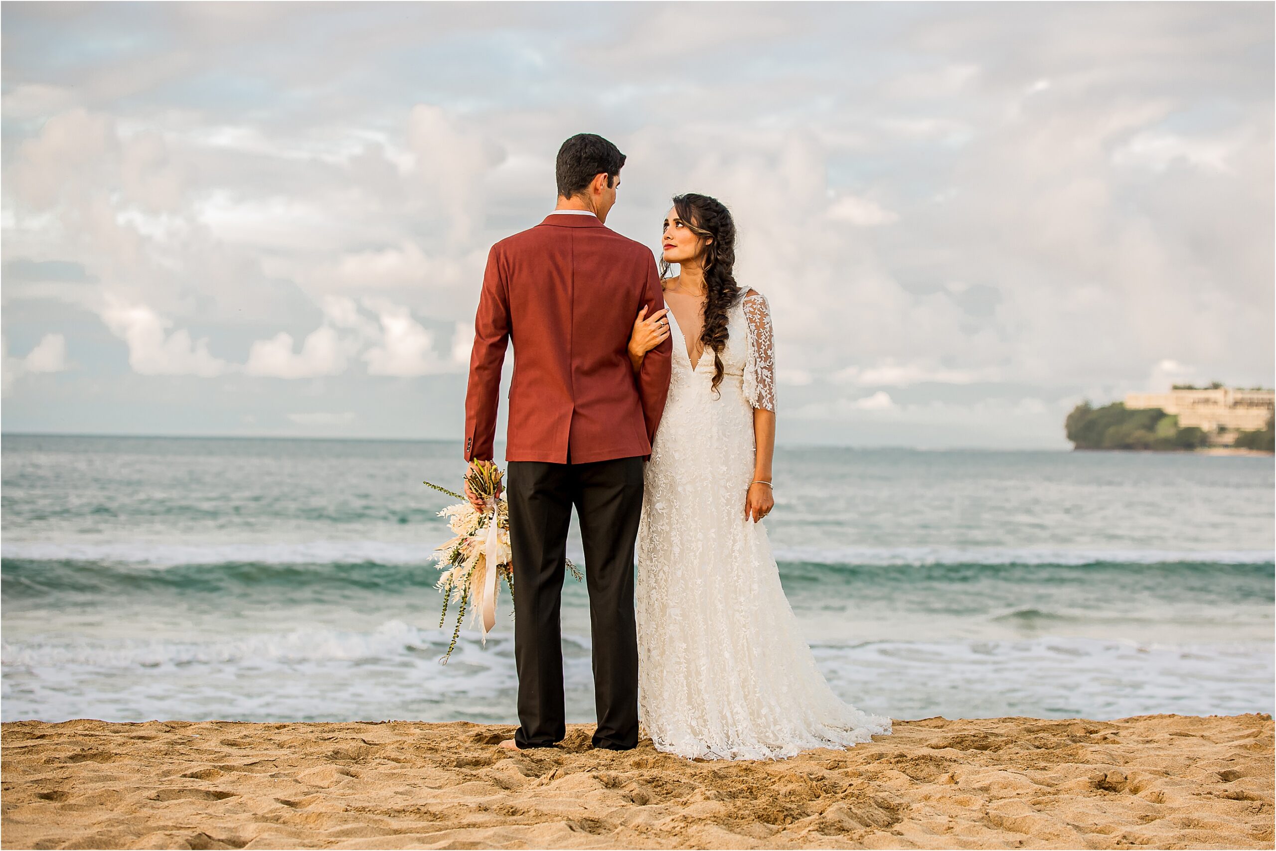 Bride and groom on the beach at sunset for their elopement